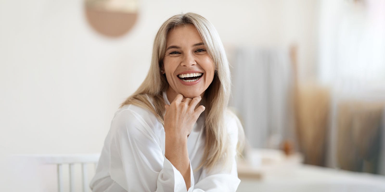 older woman smiling after getting dermal fillers in Boston, MA
