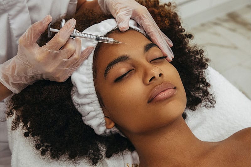 woman getting juvederm injections in her forehead in Boston, MA