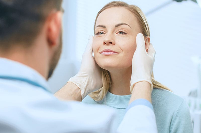 woman having a consultation with her facelift surgeon in Boston, MA