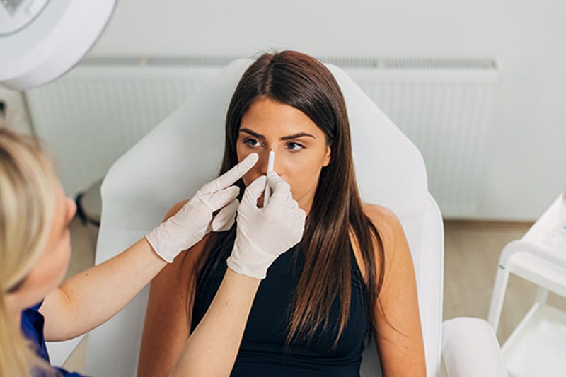 woman having a revision rhinoplasty consultation in Boston, MA